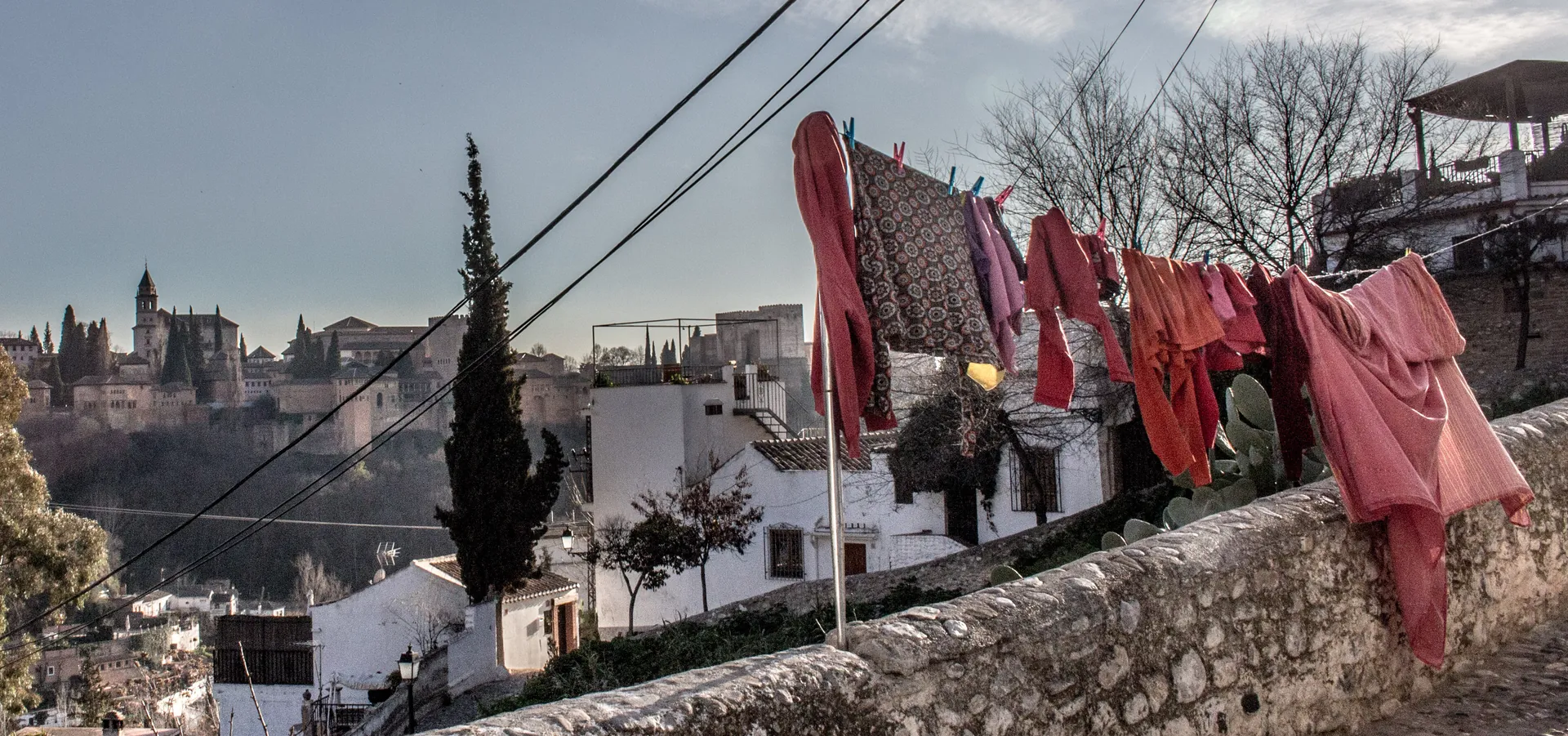 A washing line on a Sacromonte wall with the Alhambra on the hill beyond; a general photograph of the quarter